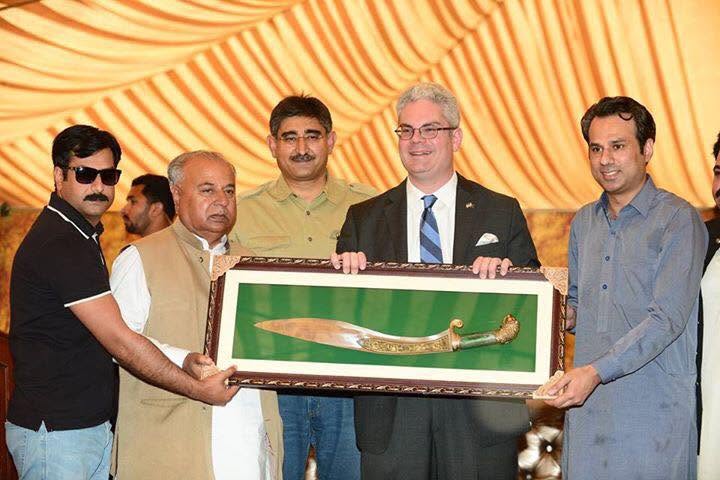 Farm representatives present a ceremonial sword to the Portuguese Ambassador
