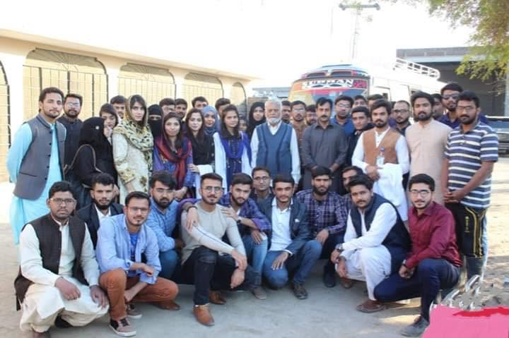University students and faculty visiting the farm